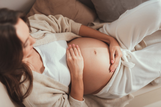 pregnant woman holding her belly 